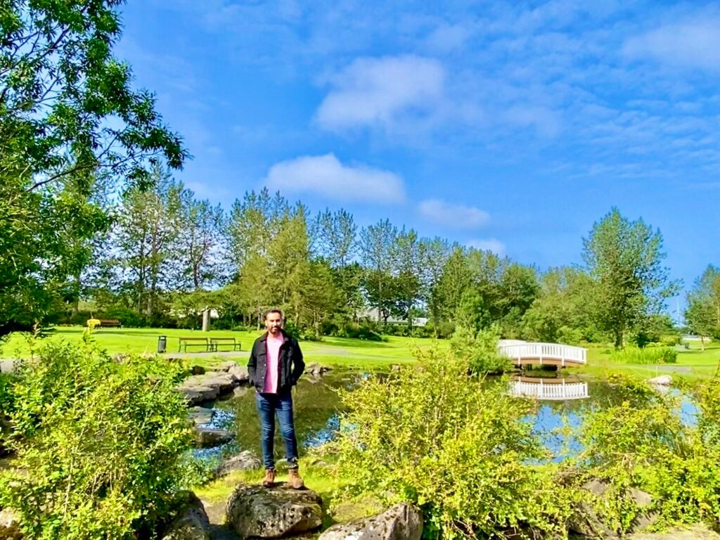 Standing beside a pond in Laugardalur Park, Reykjavík
