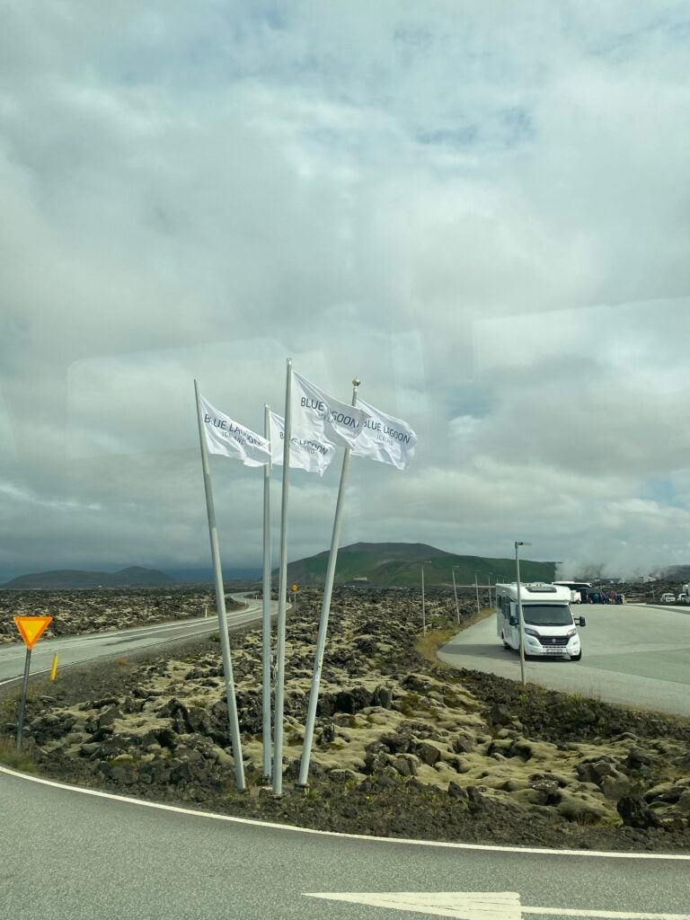 Flags beside a road through the lava fields near the Blue Lagoon